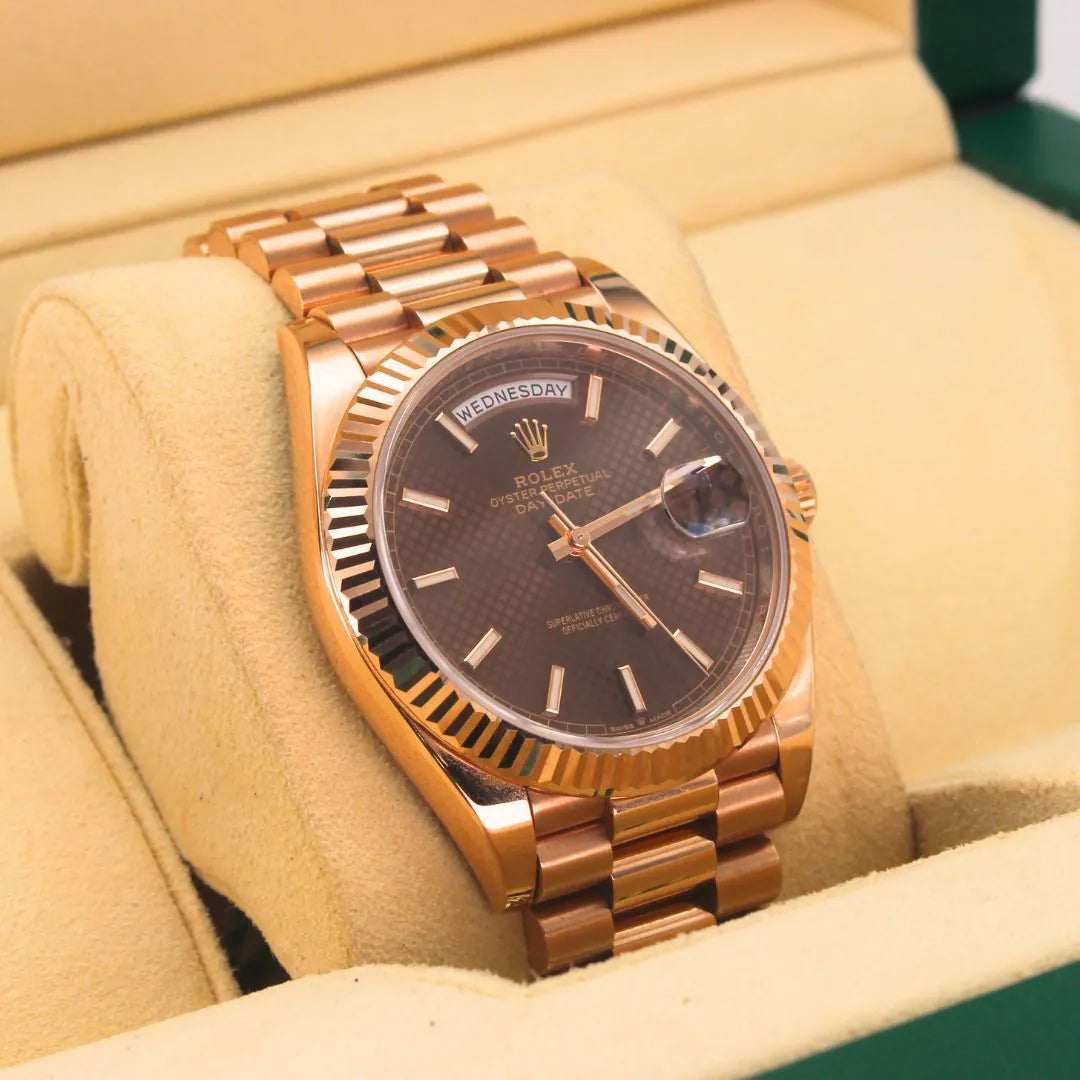 Rolex Day-Date 40 228235 Chocolate Motif Dial Rose gold watch with a brown dial on a beige cushion